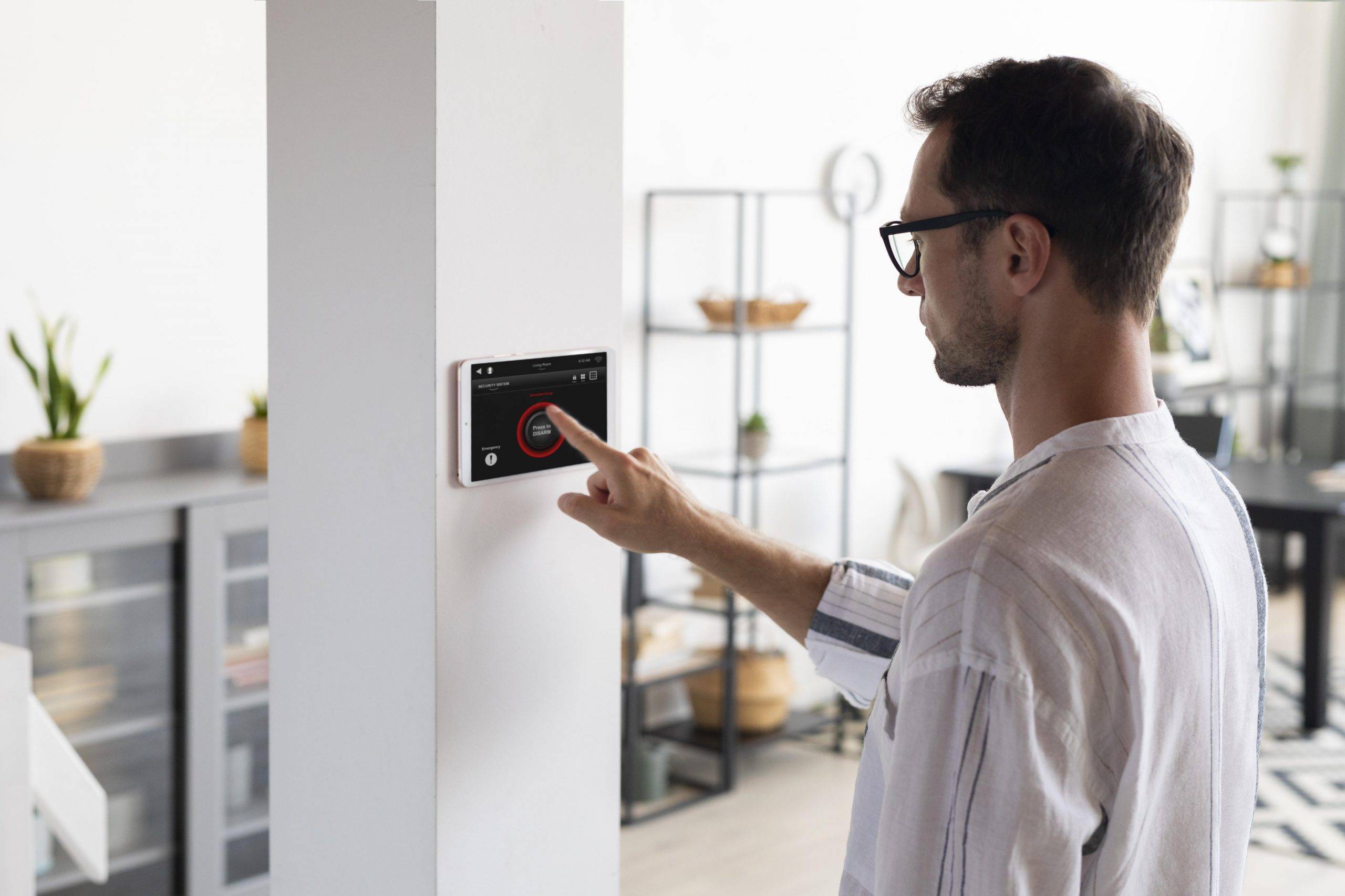 Man Using A Tablet In His Smart Home Scaled